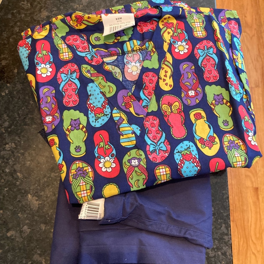 All heart summer scrubs size XSM navy blue bottoms and flip-flop sandals on top
